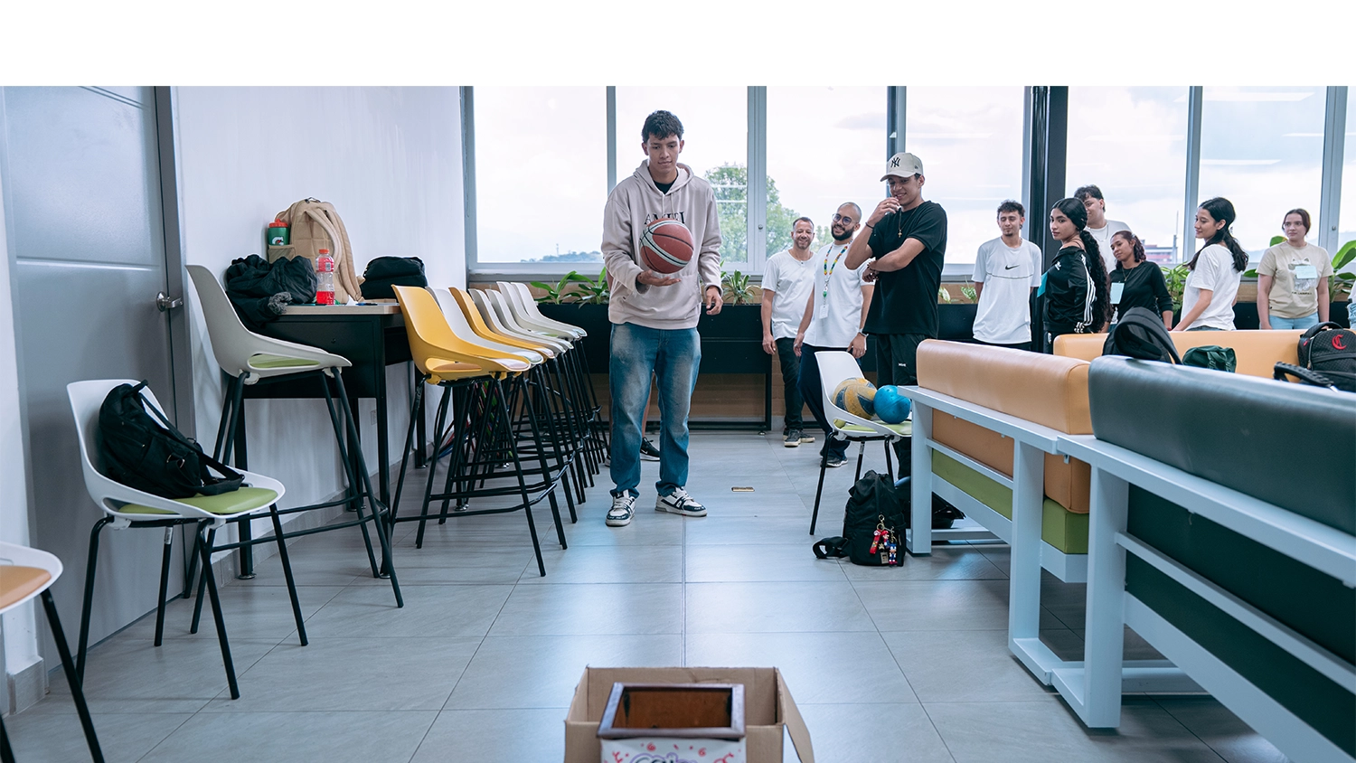Estudiantes lanza un balón de basquetball a una caja en una de las actividades de este encuentro.